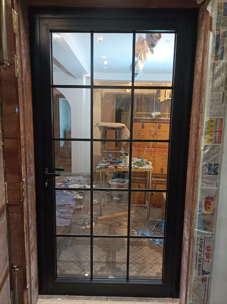 Black aluminium single door with a rectangular grid design