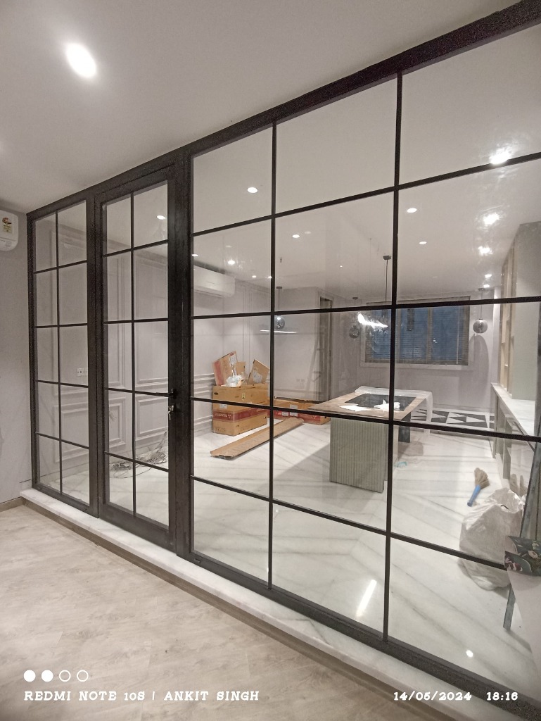 Black-framed glass partition with a grid pattern